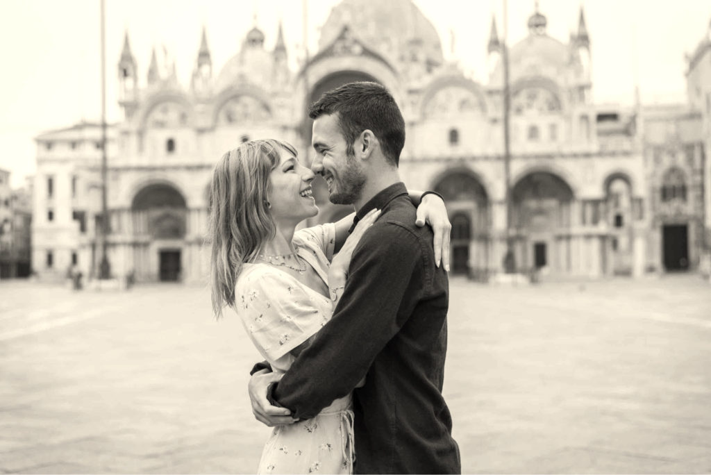 Beautiful young couple enjoying a good time in Venice with black and white look and feel
